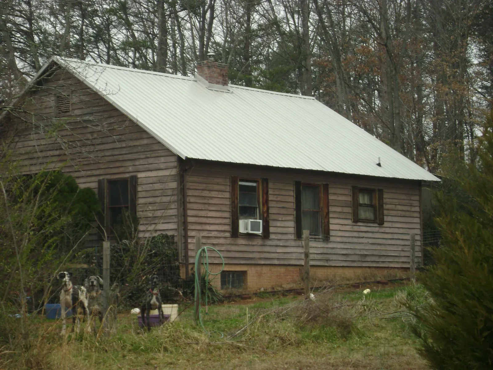 White metal roof on an old wood sided farmhouse, from a Metal Roof Installation job in Linton